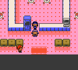 "Pokémon Crystal Version" screenshot of the player character in the Battle Tower lobby standing directly under the desk clerk NPC. Another NPC stands further south by the entrance.